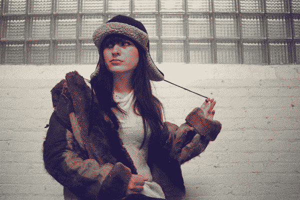 underscores wearing all-black clothing and looking to the side