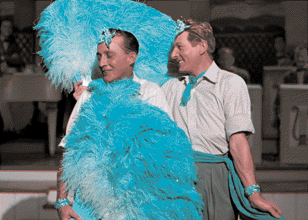 Bing Crosby and Danny Kaye holding flouncy blue feather fans in White Christmas