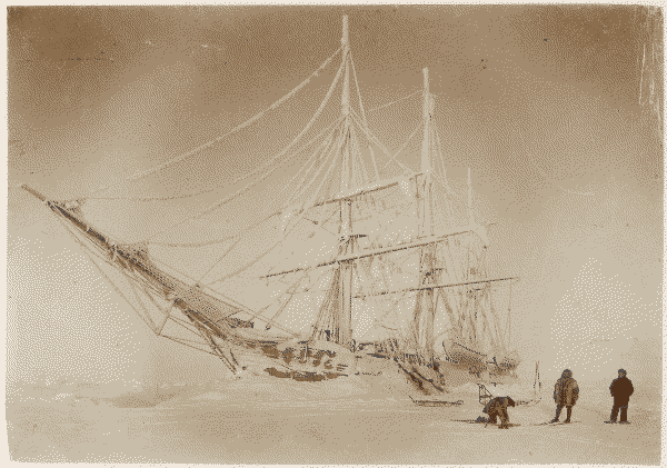 The Belgica surrounded by drifts of ice, with three crew in the foreground