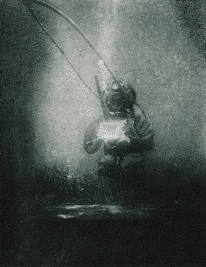 Emil Racoviță underwater wearing a diving helmet and other equipment