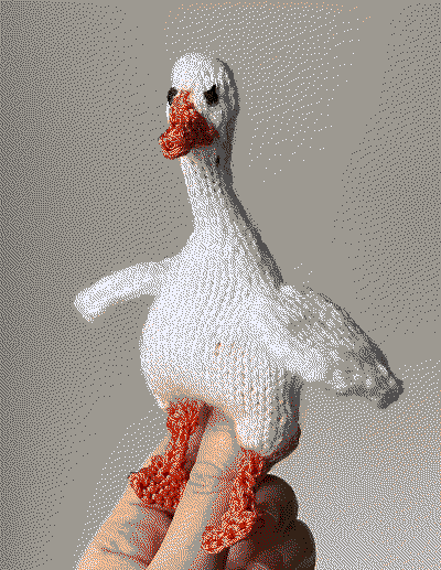 A white knitted goose about four inches tall