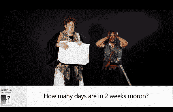 A robe-wearing man clutches a calendar while another man with a sword on his belt screams in frustration. Below, a forums post from user Justin-27 asks, "How many days are in 2 weeks moron?"